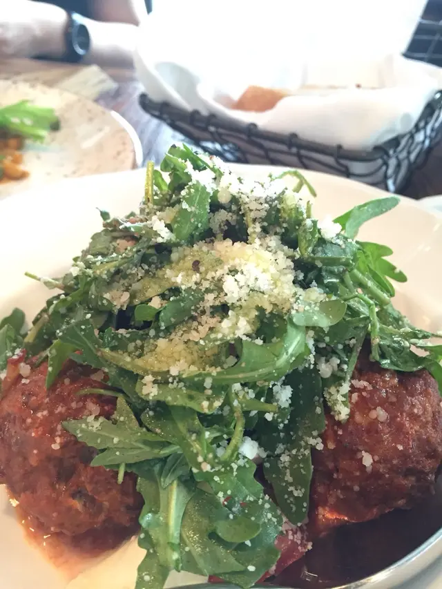 Hand ground veal and pork meatballs / pesto marinated tomatoes / mozzarella / arugula