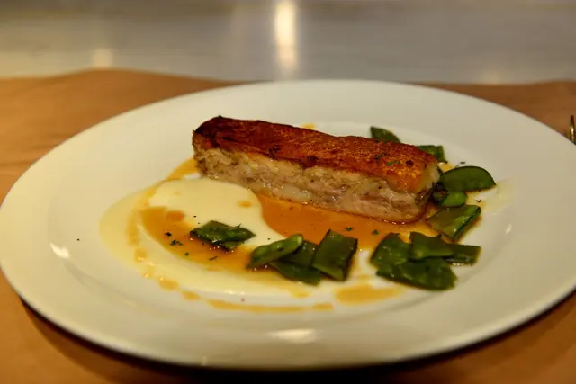SLOW COOKED SUCKLING PIG TERRINE WITH POTATO FOAM AND SEASONAL VEGETABLES