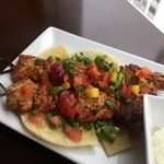 Shish Taouk - Succulent grilled chicken skewers served on Lebanese bread with garlic sauce