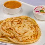 Singapore Paratha served with curry and raita