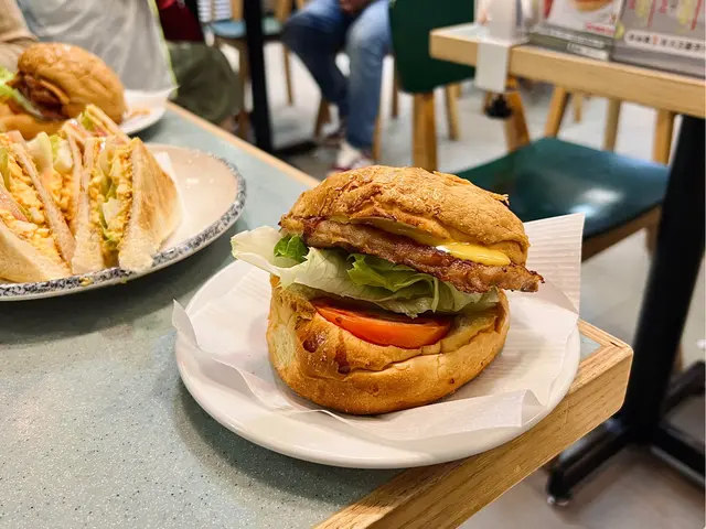 Savoury  pineapple  bun  with  juicy  pork chop  and  fresh  lettuce  &  tomato