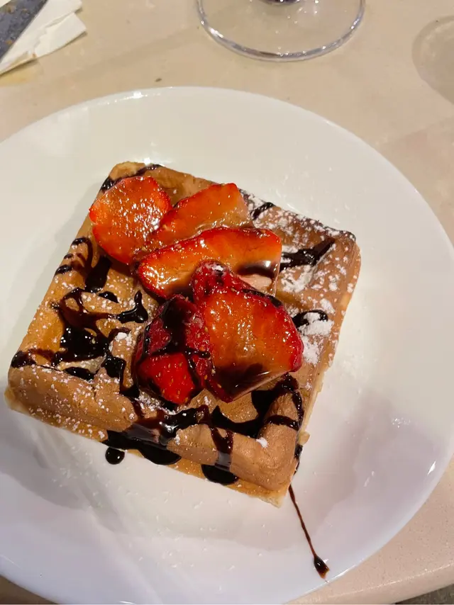 Waffle with chocolate sauce and strawberries  