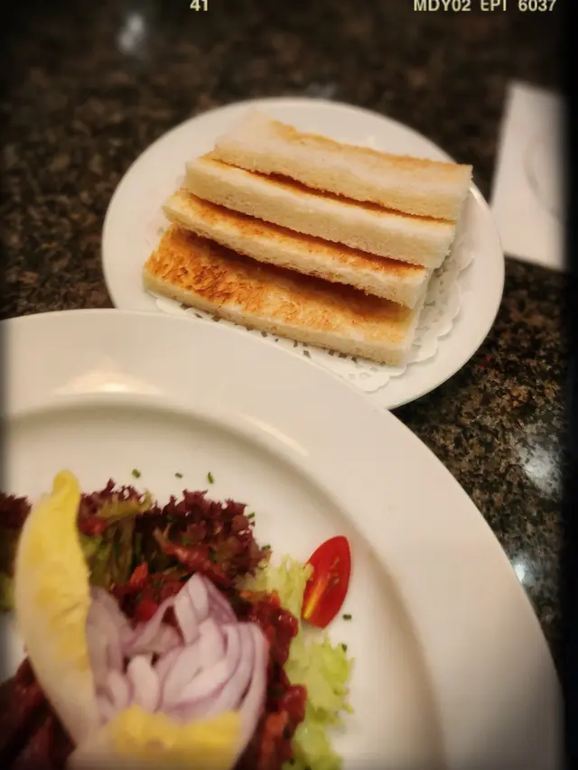 Beef Tartar flavored with Calvados with toast