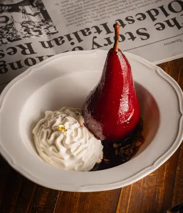 Red wine braised pear, vanilla whipped cream, crushed almond
